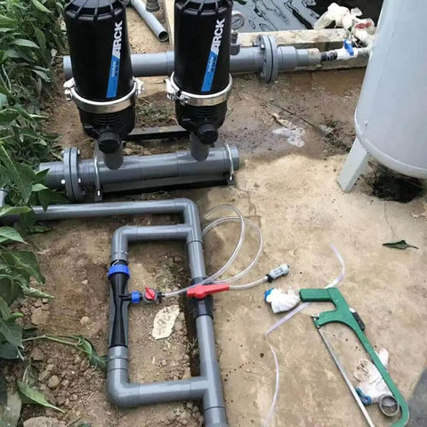Installed 1 Inch Black Venturi Injector Tube for outdoor garden and farm use with durable polypropylene construction and chemical resistance.