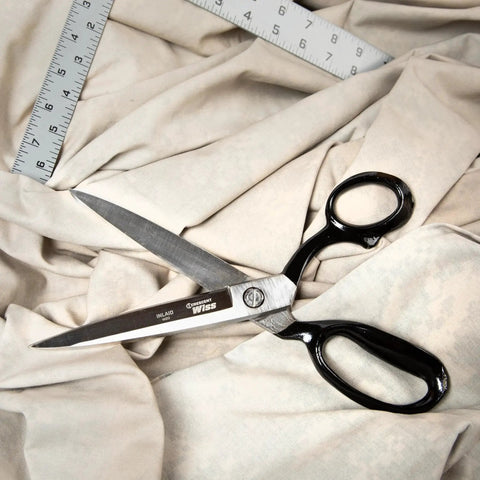 10 Inch Bent Handle Industrial Shears on fabric, used for heavy duty cutting of upholstery, carpet, and drapery materials.