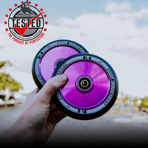 Hands holding 110mm AIR Scooter Wheels Black Purple Lightweight Durable Pro Scooter Wheels Designed for Smooth Control Easy Installation
