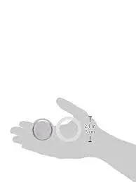 Front view of a hand holding three replacement seals and one filter for a 6-cup Bialetti Moka Express.