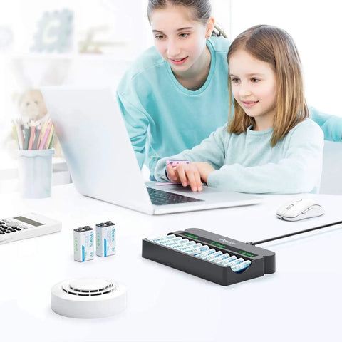 Mother and daughter using a laptop with a 12 Bay Independent Fast Charging Battery Charger For AA AAA 9V NiMH NiCd LCD on the desk