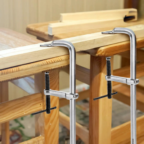 4 Pack 12 Inch Bar Clamps For Welding And Woodworking, Drop Forged Steel F Clamps in use on wooden table, light duty clamp set for crafts.