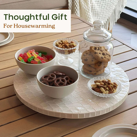 12 inch white capiz lazy susan turntable centerpiece with snacks and a cookie jar on a dining table.