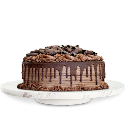 Marble lazy susan turntable designed as a cheese board and cake stand, 12 inch natural white marble rotating tray with a chocolate cake.