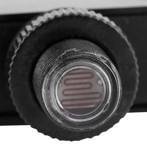 Close-up of 120V Outdoor Photoelectric Switch with Light Sensor for exterior lighting fixtures, dusk to dawn smart lighting control.