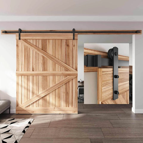 12 FT Heavy Duty Sliding Barn Door Hardware Track Kit with straight pulley, installed on wood door, black powder-coated steel