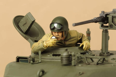 Realistic 1 To 35 US Medium Tank M4A3E8 Sherman Scale Plastic Model Kit With Slide Molded Turret And Welded Hull Texture By Tamiya showing a detailed commander figure in hatch.