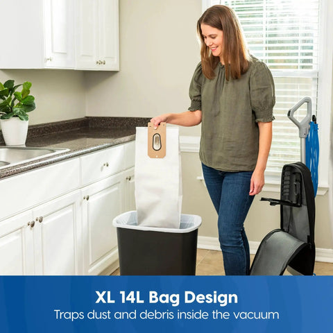Person handling large vacuum bag in kitchen for Ultra Lightweight 14L Bagged Upright Vacuum Cleaner With LED Headlight And 2 Speed Settings
