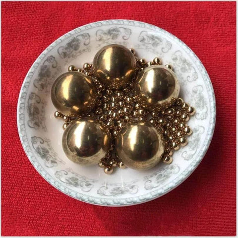 5 Brass ball beads displayed in a decorative bowl, from the 15.8mm 20pcs Solid Pure Copper Balls - Brass Ball Bead pack.