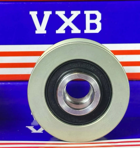 Front view of a silver metal alternator pulley with inner bearing, resting on a VXB Bearings box.