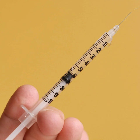 1 mL Syringes With 31G Needle Five Sixteenth Inch Length Individually Wrapped Pack Of 100 For Lab Use, close-up view in hand