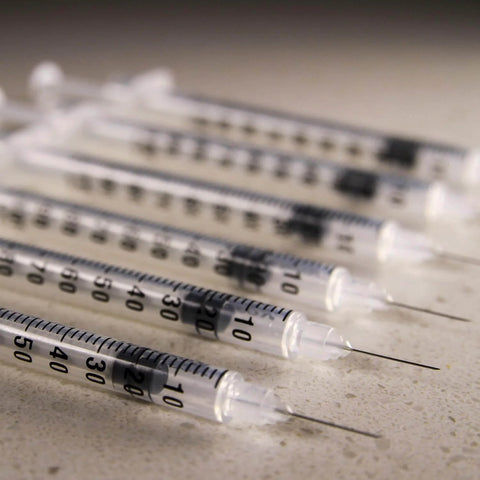 Close-up of 1 mL Syringes With 31G Needle Five Sixteenth Inch Length Individually Wrapped Pack Of 100 For Lab Use