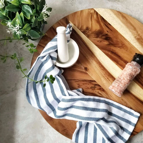 20 inch acacia wood lazy susan turntable designed for tables and counters with decor, towel, and seasoning jar.