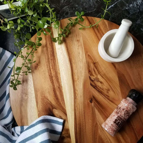 20 inch acacia wood lazy susan turntable designed for tables and counters, grand rotating wooden organizer on marble surface.