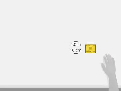 Hand measuring 4-inch by 10 cm space with yellow sticky note.