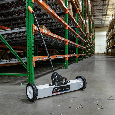 24 Inch Rolling Magnetic Floor Sweeper With 50 Pound Capacity And Adjustable Handle From 29 To 42 Inches With Floor Magnet Clearance Height For Fast Safe Pickup Of Nails Screws And Ferrous Metal Debris On Construction Jobsites And Shop Floors on warehouse floor.
