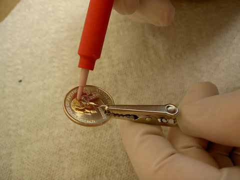 Using Brush Plating Kit With 24K Gold Solution Complete Gold Plating System for precise gold finish on a coin.