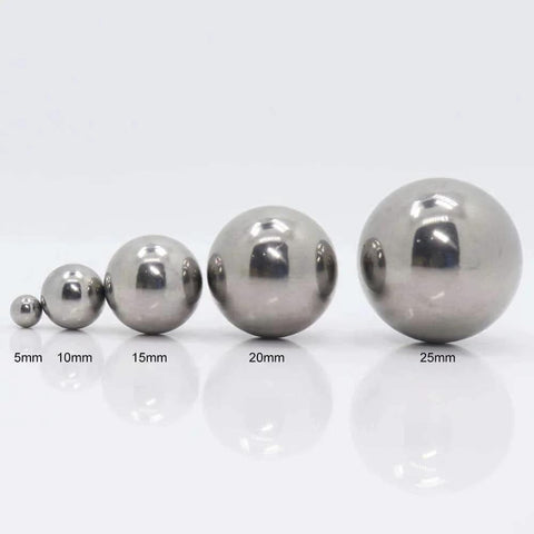 Four different sizes of mirror-finish steel balls - 5mm, 10mm, 15mm, 20mm, and 25mm diameter for garden decor and precision projects