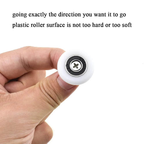 Hand holding 25mm diameter bearing steel shower door wheel with nylon roller, stainless steel screw, and ball bearing.