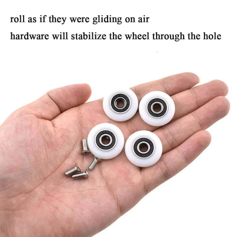 25mm diameter bearing steel shower door wheels with nylon rollers and stainless steel screws on a hand