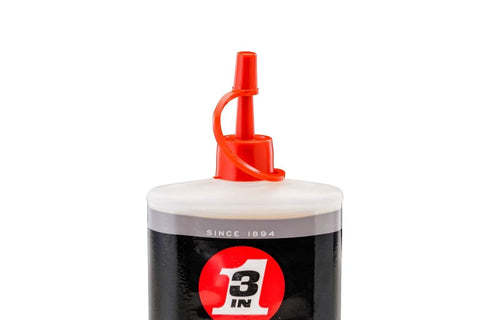 Close-up of 3-IN-ONE Multi-Purpose Oil, 8 OZ squeeze bottle with red precision spout, focus on top section.