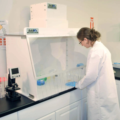 Lab technician using 30 Inch Wide Portable Laminar Flow Hood Lab Grade For Medical And Laboratory Use with positive pressure