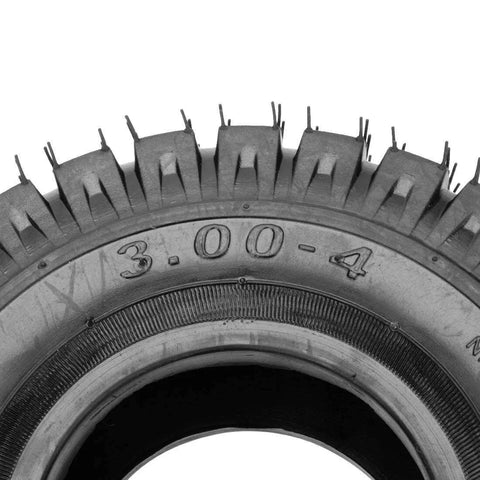 Close-up of 3.00-4 260 x 85 tire with knobby tread for scooters and go-karts, showing TR87 valve stem.