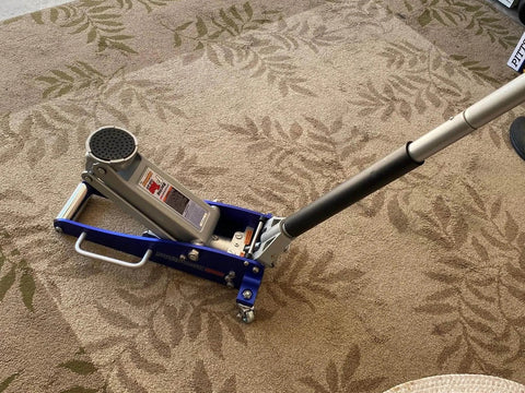 3000 Lb Aluminum Racing Car Auto Floor Jack Low Profile Rapid Pump Lift shown on carpet, handle extended, blue frame visible