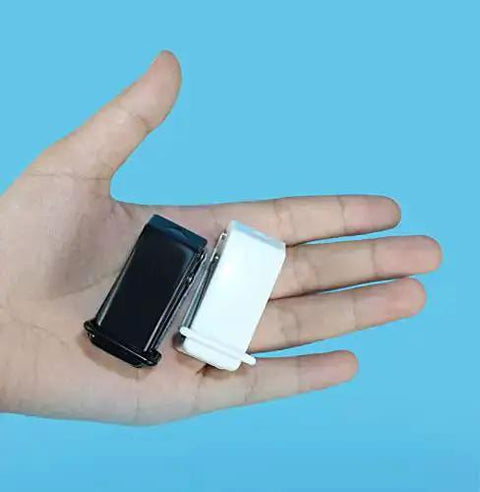 Hand holding Two Pack Small Black And White One Quarter Inch Circle Hole Punch Handheld Tool for paper and leather craft, blue background.