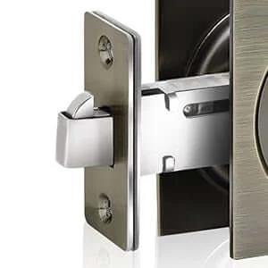 Close-up view of Privacy Pocket Door Lock And Pull In Stainless Steel 304 With Antique Brass Finish Emergency Unlock Feature
