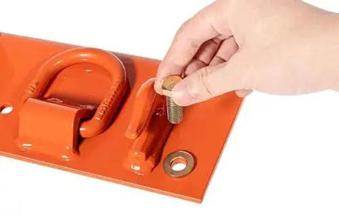 Close-up of Bolt On Tractor Grab Hooks For Kubota Buckets With D Rings 2In Receiver Orange being installed on an orange plate.
