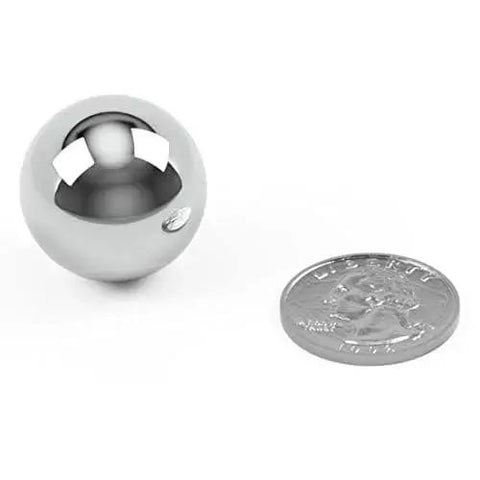 Five 1 Inch Chrome Steel Bearing Balls G25 For Precision Machinery And Industrial Use next to a quarter for size comparison.