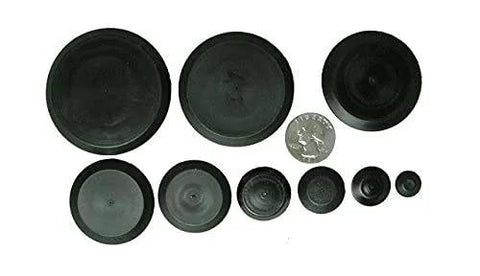Assorted sizes of Fifty Piece Flush Mount Plastic Hole Plug Set For Auto Body And Sheet Metal displayed on a white background with a coin for scale.