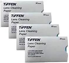 Tiffen Lens Cleaning Tissue Paper Pack Of 50 Sheets For Cameras in sealed packaging, shown in four white boxes.