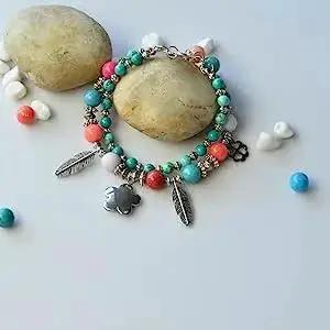 Colorful bracelet made with Antique Silver Tibetan Style Pumpkin Spacer Beads 4mm, adorned with feather and flower charms.