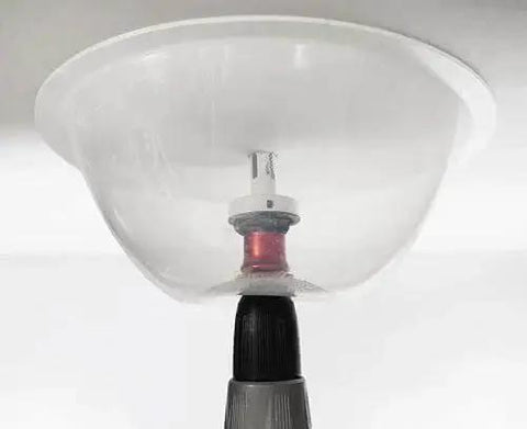 Mess Free RemGrit Blu Mol Collapsible Dust Bowl for hole saws and recessed light installations in use on ceiling by Disston