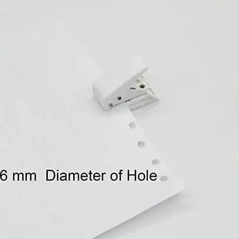 White handheld tool punching holes in paper, Two Pack Small Black And White One Quarter Inch Circle Hole Punch Handheld Tool