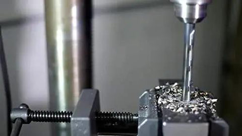 Close-up of Three Piece HSS KFD Drill Bit Sample Pack One Eighth To One Quarter Inch Split Point drilling in stainless steel.