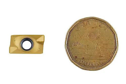 APKT1604 TiN Coated Carbide Insert next to a Canadian dollar coin for scale comparison