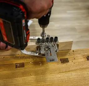 Weekend Hobbyist Stainless Dowelling Jig Kit With One Quarter Inch, Three Eighth Inch, And One Half Inch Holes in use by DIYer