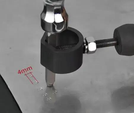 Close-up of DIY 4MM Steel Die Stamping Kit use on metal surface, part of Durable Aluminum Replacement Tag Kit for trailers and trucks.