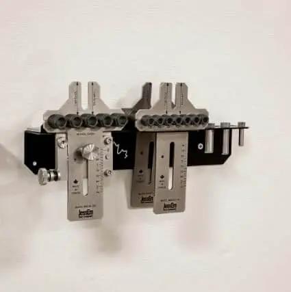 Weekend Hobbyist Stainless Dowelling Jig Kit With One Quarter Inch, Three Eighth Inch, And One Half Inch Holes mounted on wall