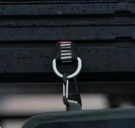 Close-up of T Slot Loop 4 Pack Heavy Duty Roof Rack Tie Down Anchors for Roof Top Tents, showing aluminum D ring attachment system.