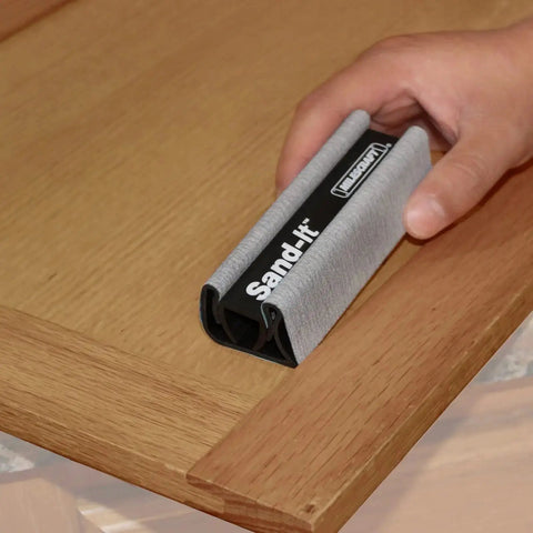 Hand using 4 In 1 Sanding Block For Flat Convex Concave And Round Surfaces on wooden corner