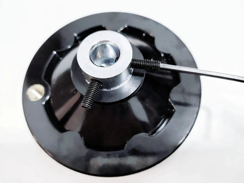 Close-up of top view showing set screws on four inch metal handwheel for half inch shaft with hex key wrench for table saws and CNC machines.