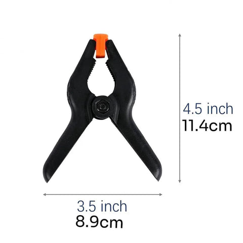 Plastic spring clamp, 4.5-inch, black with orange jaw tip, heavy-duty clip for photography and backdrops