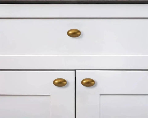 Antique Brass Cabinet Knobs 10 Pack 1-3/8 Inch Oval Drawer Knobs installed on white kitchen cabinets
