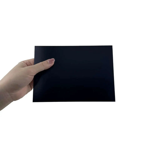 Hand holding Premium Black Anodized Aluminum Sheets 5x7 Inch One Thirty Second Inch 0.8mm Corrosion Resistant Plates for DIY crafts