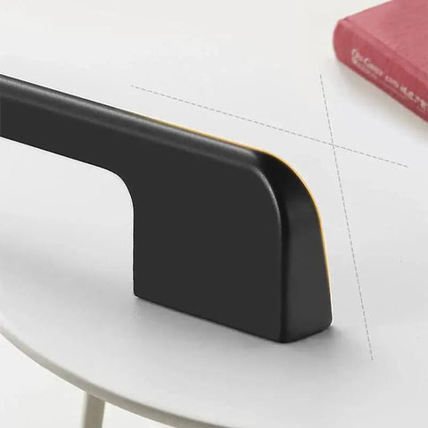 Close-up of Five Pack Solid Black Long Cabinet Handles Five Point Eight Three Inch Drawer Pulls on a white surface.