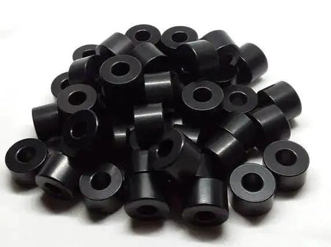 Pile of Half Inch Aluminum Spacer Black Anodized Round Unthreaded Standoff Bushing with Quarter Inch Inner Diameter For Quarter Inch Screws Or M6 Bolts